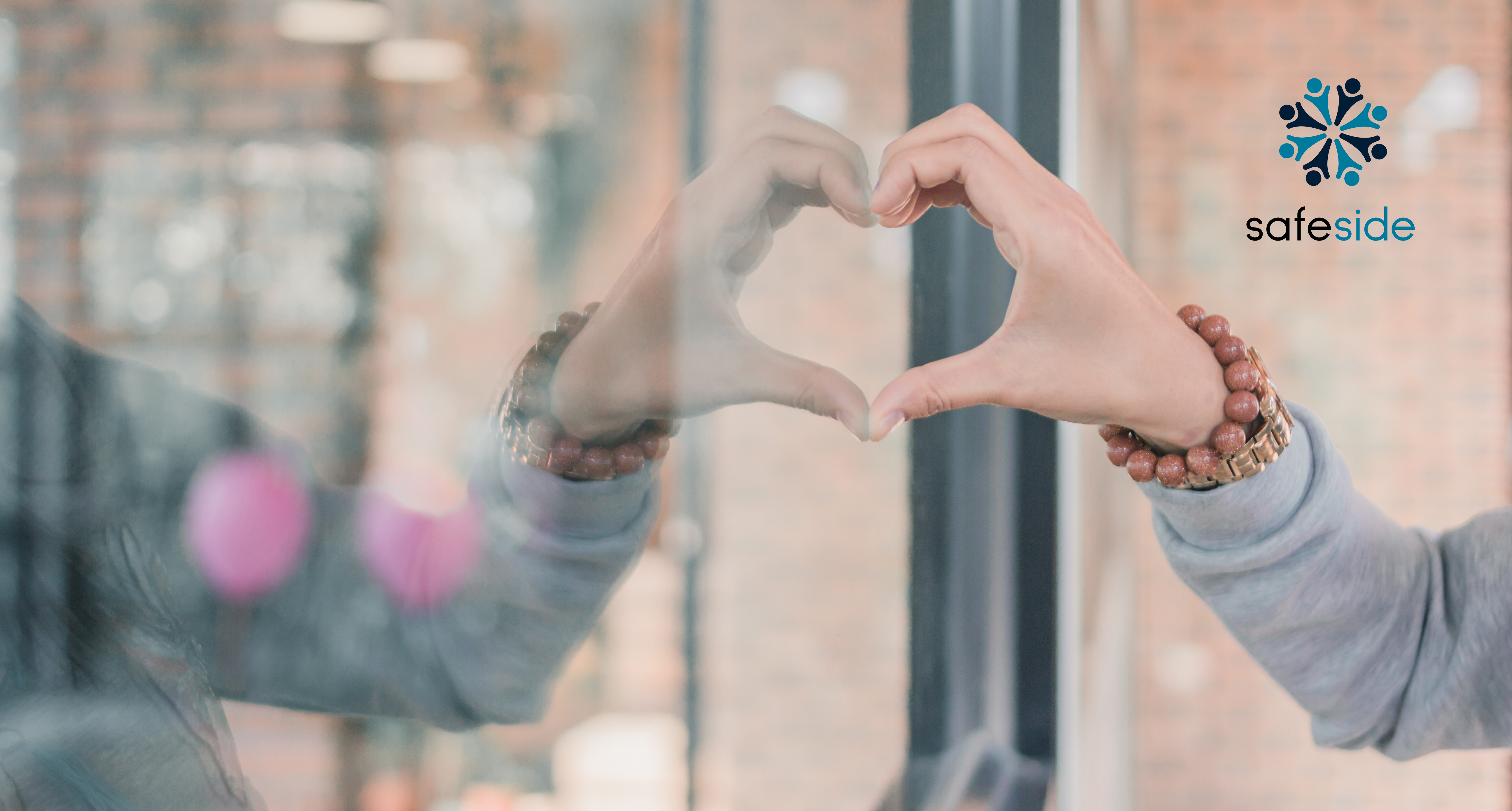 Hand forming heart with mirror